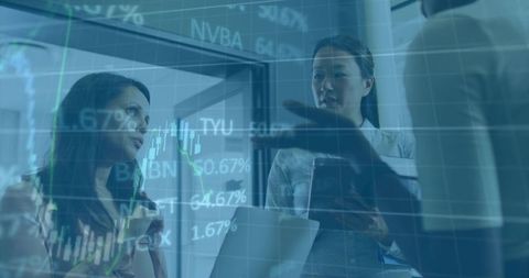 Businesswomen Analyzing Stock Data in Modern Office Setting