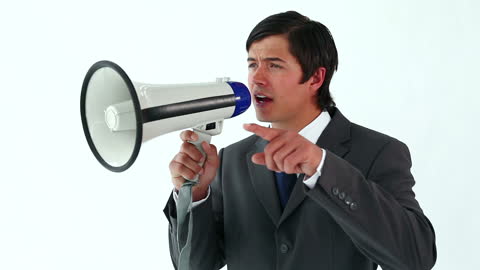 Professional Man Communicating with Megaphone in Studio