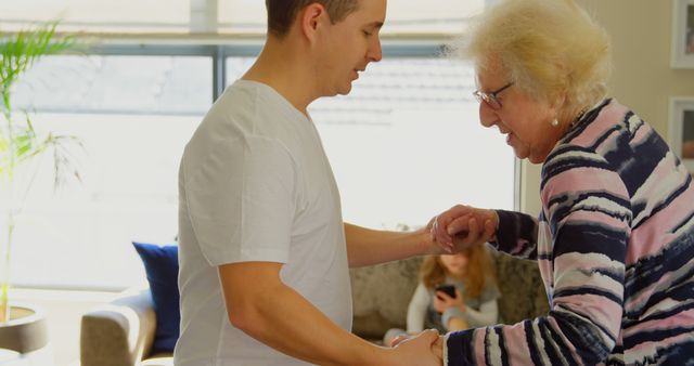 Young Man Assisting Elderly Woman Indoors - Download Free Stock Images Pikwizard.com