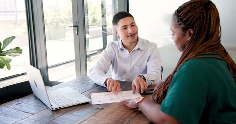 Business team discussing documents at office meeting table