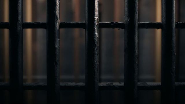 Dimly Lit Prison Bars Connoting Confinement and Isolation