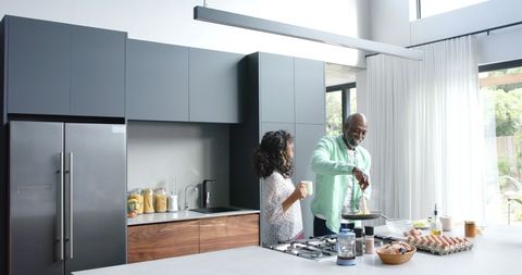 Joyful Couple Cooking Breakfast Together in Modern Kitchen