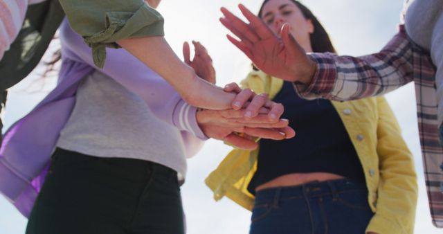 Friends Stacking Hands Outdoors Celebrating Togetherness - Download Free Stock Images Pikwizard.com