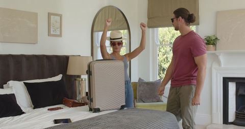Couple Packing Luggage Ready for Vacation in Cozy Bedroom
