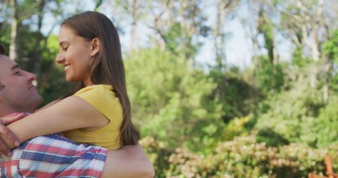 Joyful Couple Embracing Outdoors in Sunlit Park - Download Free Stock Images Pikwizard.com