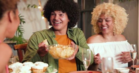 Friends Celebrating with Snacks and Champagne