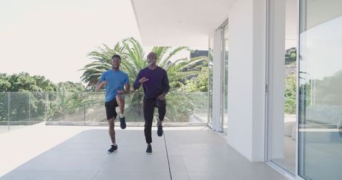 Father and son exercising on modern terrace