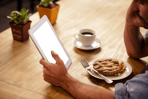 man using tablet in cafe with dessert and coffee on table - Download Free Stock Videos Pikwizard.com