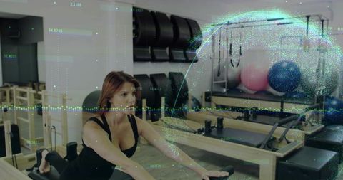 Woman reaching on pilates reformer building core strength and balance