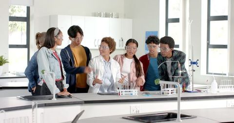 Teenagers Collaborating on Chemistry Experiment in School Lab