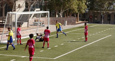 Youth soccer match with players on field preparing for corner kick