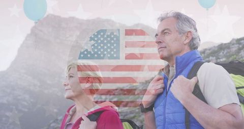 Senior Couple Hiking with American Flag Overlay in Peaceful Mountains