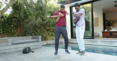 Diverse Friends Enjoy Poolside Stretching Exercise Session