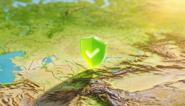Green shield with checkmark hovering over topographic map representing geolocation security