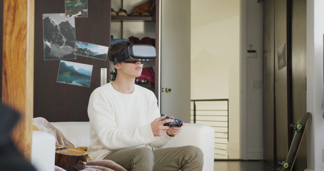 Young Man Using VR Headset for Gaming in Modern Living Room - Download Free Stock Images Pikwizard.com