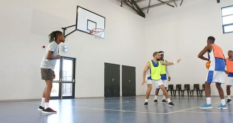 Basketball Team Practicing Drills on Indoor Court