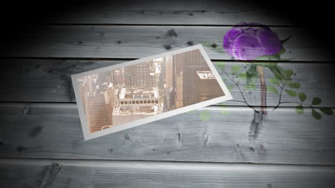 Tablet Displaying Cityscape on Wooden Surface with Flower Illustration