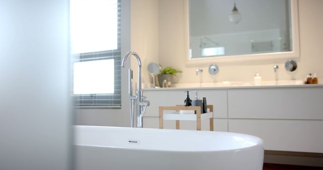 Empty white bathroom with big bath and cosmetics on shelf - Download Free Stock Photos Pikwizard.com