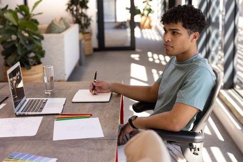 Young professional planning project in sunlit creative office