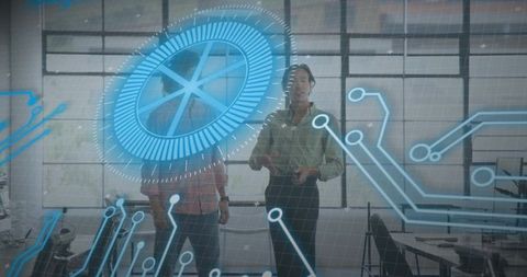 Two male colleagues collaborating with holographic circular HUD in modern office