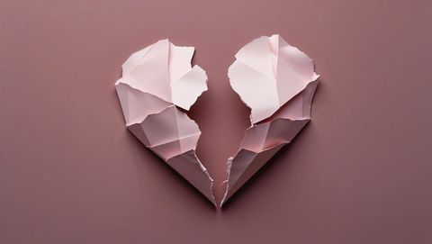 Torn paper broken heart symbolizing emotional fragility