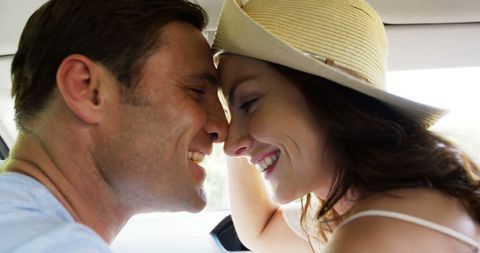 Romantic couple sharing intimate moment in convertible car