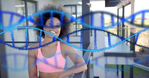 Smiling woman leaning on modern balcony wearing pink activewear with dna helix overlay