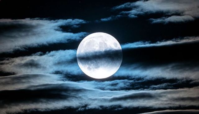 Glowing Full Moon Behind Veiled Clouds Creating Cinematic Blue Lunar Glow for Design