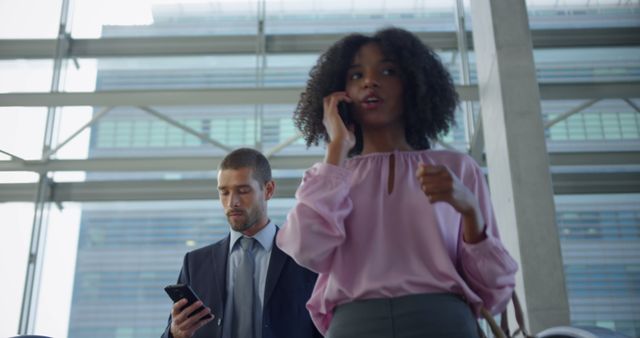 Business Professionals Talking on Phones in Modern Office Building - Download Free Stock Images Pikwizard.com