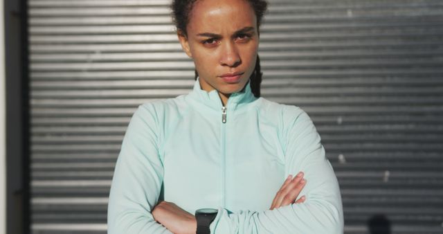 Confident Female Athlete in Workout Gear with Arms Folded Outdoors - Download Free Stock Images Pikwizard.com