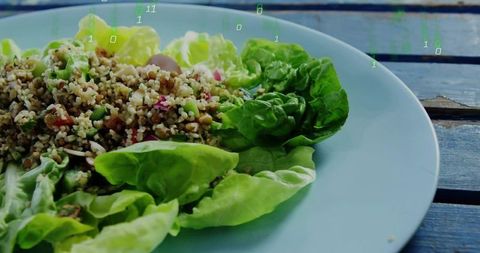 Serving bulgur and butterhead lettuce grain salad on blue plate with subtle binary overlay