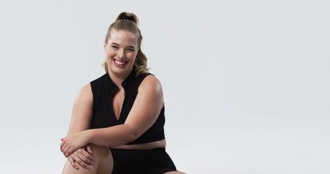 Confident Plus Size Woman Smiling in Casual Outfit with White Background