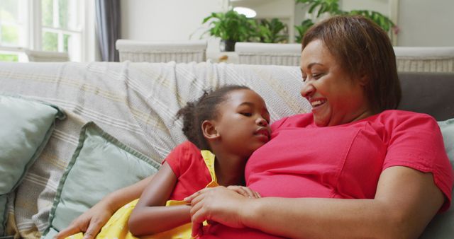 Mother and Daughter Relaxing on Sofa at Home - Download Free Stock Images Pikwizard.com