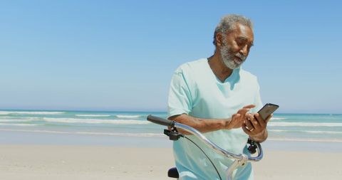 Senior Man Taking Selfie on Beach with Bicycle in Sunshine - Download Free Stock Images Pikwizard.com