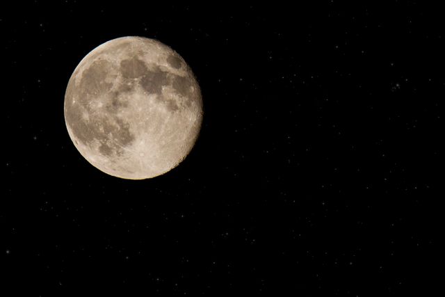 Glowing full moon in a clear night sky with stars can be used for astronomy presentations, educational content, space-themed decorations, websites, and to illustrate stories or articles related to moon phases and lunar observations.