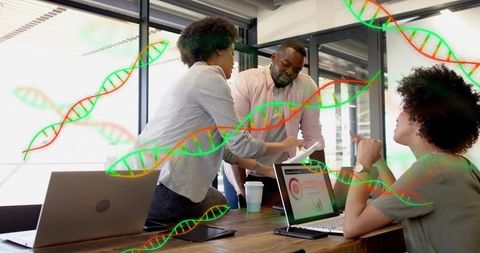 Collaborating biotech team reviewing tablet and laptops with dna helix overlays for analytics