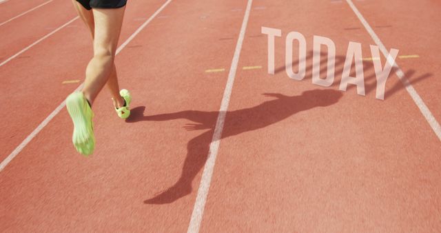 A young athlete's legs are in motion on a running track, with the word TODAY superimposed in large letters, with copy space. Highlighting a sense of immediacy and motivation, the image captures the essence of seizing the day and the determination in sports.