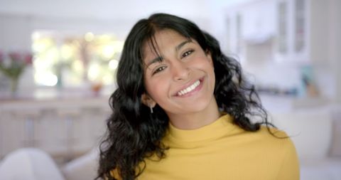 Cheerful Biracial Teenager with Long Hair at Home