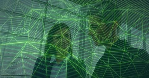 Businesswomen collaborating under green digital mesh overlay representing teamwork and tech
