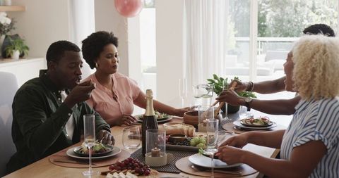 Friends Sharing Laughter and Lunch in Bright Setting