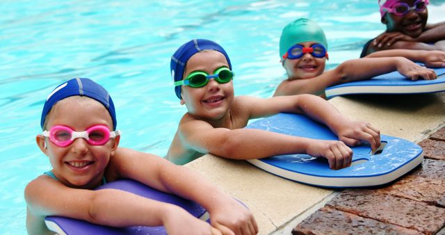 Smiling Children Learning to Swim with Kickboards in Swimming Pool - Download Free Stock Images Pikwizard.com