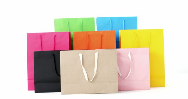 Perfect for illustrating retail, shopping, and consumerism themes. Useful for marketing campaigns, advertisements, and ecommerce websites promoting sales and product packaging. The variety of colorful bags offers versatility for creating visually appealing content.