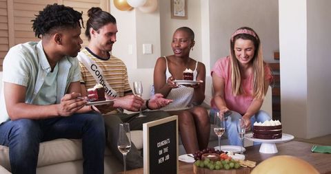 Friends Celebrating New Job at Home Party with Cake and Cheers