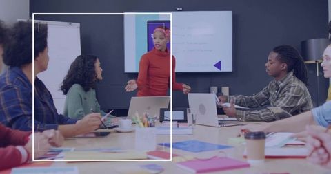 Confident Businesswoman Leading Collaborative Meeting in Modern Office
