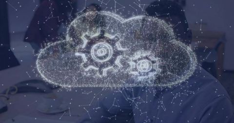 Cloud computing hologram with gears over boardroom table showing automation and collaboration