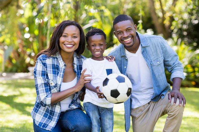 Happy African American Family Posing with Soccer Ball in Park - Download Free Stock Photos Pikwizard.com