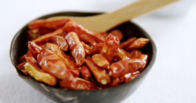 Dried Red Chilies in Black Bowl with Wooden Spoon - Download Free Stock Images Pikwizard.com