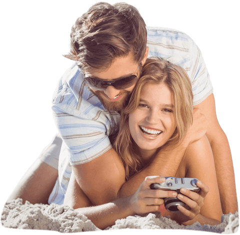 Playful Caucasian Couple with Camera on Beach Transparent Background