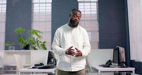 Confident Businessman Presenting in Modern Office Environment