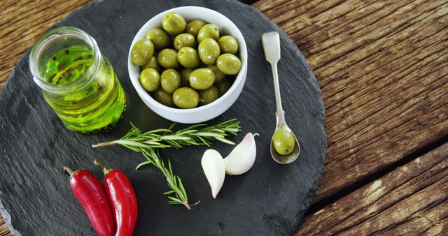 Fresh Ingredients with Green Olives, Olive Oil and Spices on Black Slate - Download Free Stock Images Pikwizard.com